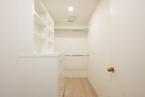 Large walk-in bedroom closet with built in shelves and drawers at 633 Palms Blvd. apartment in Venice, California.