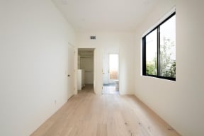 Bedroom with walk-in closet and bathroom with door to outside deck at 633 Palms Blvd. in Venice, California.