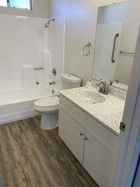 A white toilet sits next to a sink in a bathroom.