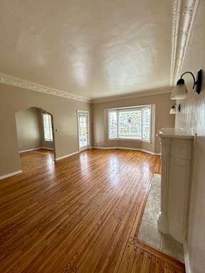 A room with wooden floors and white walls.