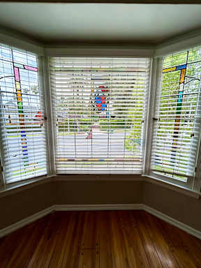 A room with a window covered in stained glass.