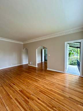 A room with wooden floors and white walls.