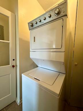 A white oven with a stove on top is in a kitchen.