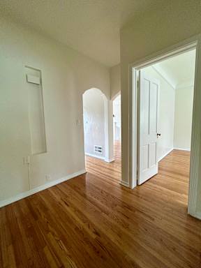 A room with wooden floors and white walls.