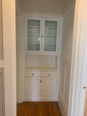 Built-in cabinet with glass doors at 900 Taylor Street Apartments.