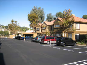 Gated parking area with plenty of surface parking and covered parking with locking storage at Grande Vista Apartments.