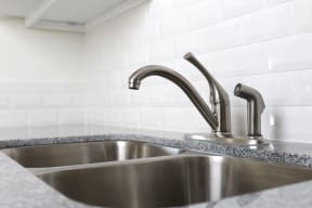 Upgraded kitchen fixtures and countertops at Harbor Villa Apartments in San Diego, California.