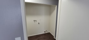 Washer/dryer hookups in hallway at Grand Oaks Apartments in Lake Elsinore, California.