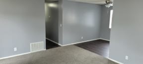 Living room view of bedroom hallway and dining room at Grand Oaks Apartments in Lake Elsinore, California.