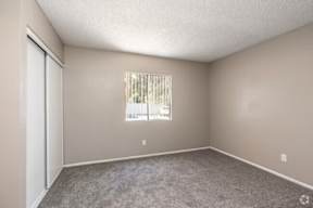 A room with a window and a door.