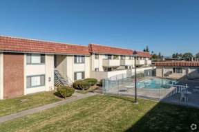 Apartment complex with a pool in the backyard.