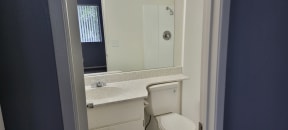 Bathroom with tub and shower at Grand Oaks Apartments in Lake Elsinore, California.
