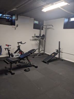 Exercise equipment in the exercise room at Molino Del Mar Apartments in Pasadena, California.