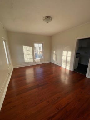 Lots of natural light and beautiful craftsmanship in living room of apartment unit at Molino Del Mar Apartments in Pasadena, California.