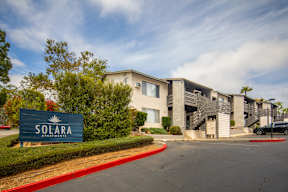 The image shows a building with a sign that reads "SOLARA APARTMENTS".