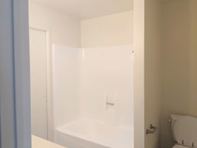 Bathtub shower and toilet in apartment unit at the Steckel Apartments in Santa Paula, California.