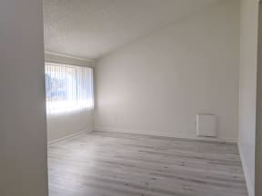 Large window with vertical blinds in spacious living room at the Steckel Apartments in Santa Paula, California.