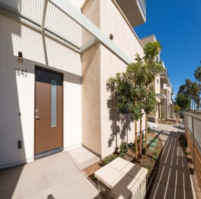 Walkway in front of apartment units at Villa Grande Apartments in San Diego, California.