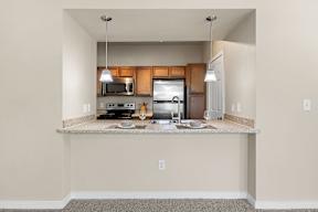 A kitchen with a counter and a microwave.