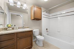 A bathroom with a toilet, sink, and bathtub.