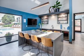 a kitchen with blue walls and a table and chairs