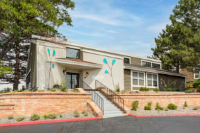 the exterior of a building with stairs and trees