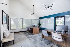 a conference room with a desk and chairs and a tv