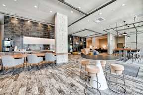 a lobby with tables and chairs and a bar