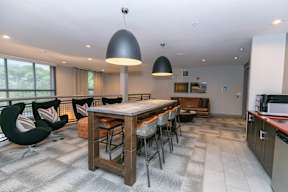 A modern kitchen with a dining table and chairs.
