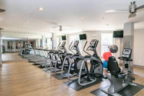 A gym with treadmills and exercise bikes.