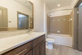 A bathroom with a white toilet and a white sink.