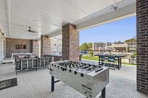 A Kettler outdoor grill is in the foreground of a patio area.