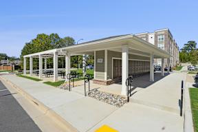 A covered walkway leads to a building with the number 1001 on it.