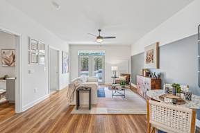 A living room with a white ceiling and a fan.