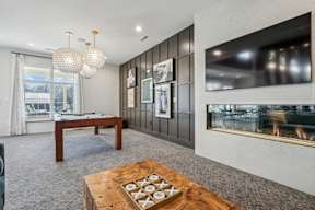 A modern living room with a fireplace and a coffee table.