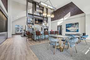 A modern dining room with a long table and chairs.