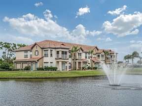 Exterior shot of the complex with body of water and fountain