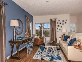 Living room with a couch and rug and a sitting chair