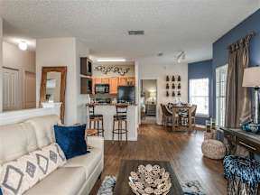Living room with couch and barstools in the background