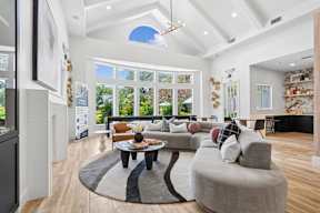 A living room with a large grey couch and a coffee table in the center.
