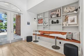 A modern living room with a white sofa and a wooden floor.