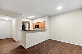 A kitchen area with a counter and cabinets.