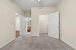 A room with a carpeted floor and white walls.