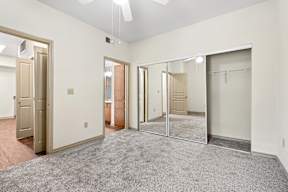 A room with a grey carpet and a white ceiling.