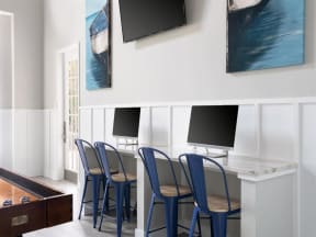 a business center with blue chairs and computers