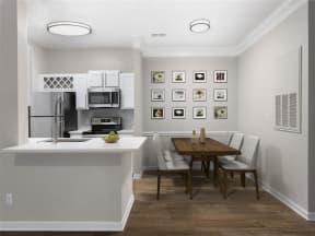 a kitchen with white cabinets and stainless steel appliances and dining area