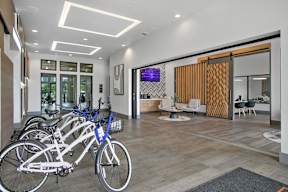 a row of bikes parked in the lobby of a building