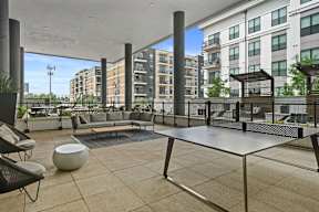 a large balcony with couches and a table