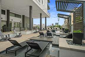 a patio area with tables and chairs and a water fountain