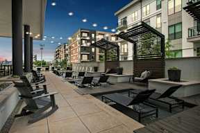 an outdoor patio with chairs and tables and buildings in the background